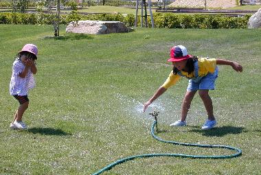 Family in the sprinkler